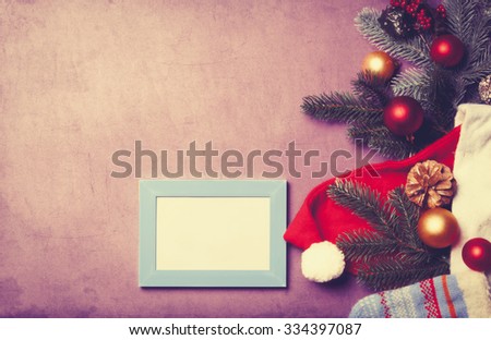 Frame and christmas gifts on violet background