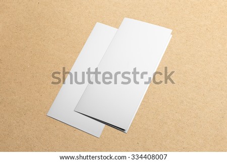Blank tri-fold brochure, leaflet isolated on cardboard background, with clipping path, changeable background