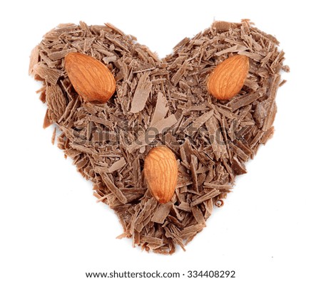 Milk chocolate shavings in shape of heart isolated on white