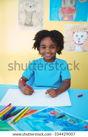 School kid drawing on a sheet in his room