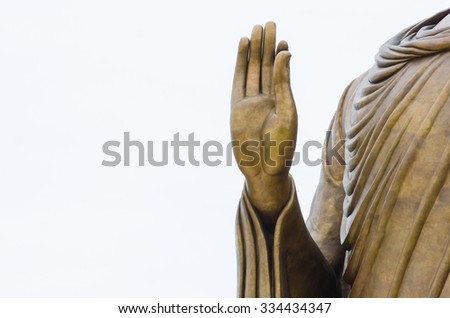 Statue hand of buddha on sky background - stock photo