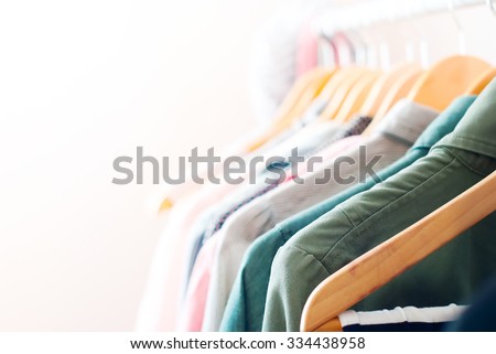 Pastel Color Clothes. Female Clothes on Open Clothes Rail Royalty-Free Stock Photo #334438958