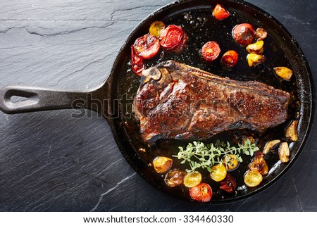 top down photo of a new york strip steak in iron skillet