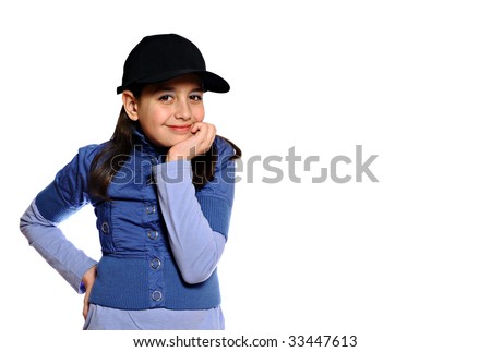 Smiling girl in blue outfit and baseball cap resting head on hands