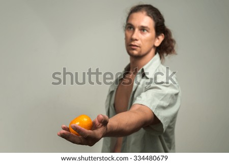 Man holding orange