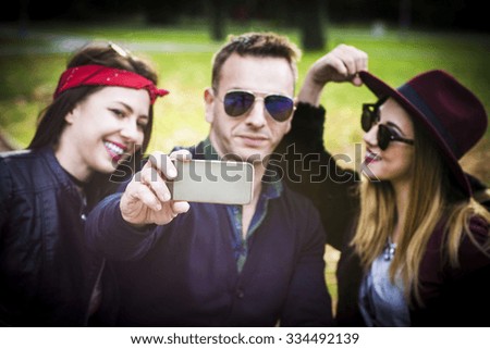 Young people with mobile phone in the park 