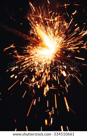 burning sparkler on a dark background