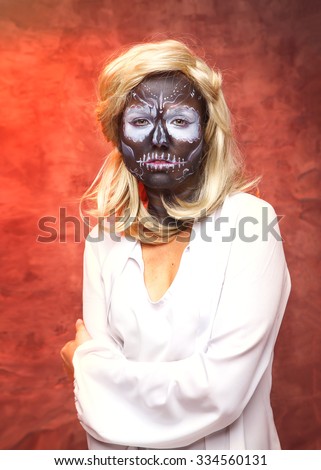 Dead bride woman in skull face dark mask. Halloween. Woman skeleton on a red black background. Halloween, make up skull. Magic sorceress - concept. Fantasy woman. Witch, zombie, skeleton.