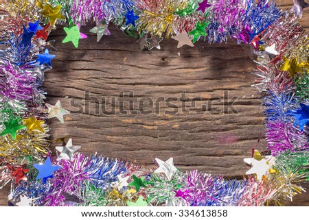 tinsel on the wooden background. frame.