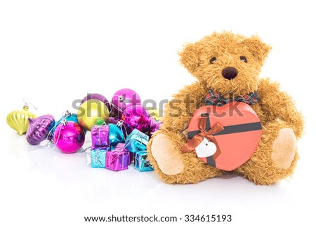 Teddy bear with  Red heart shaped gift box and gifts on white background