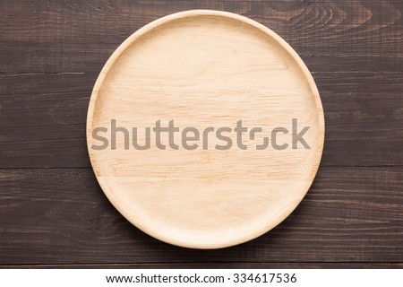 Wood dish on the wooden background. Top view.