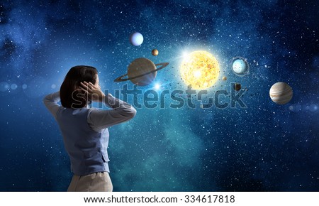 Young woman covering her ears with hands and looking at space planets