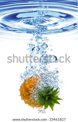 Bubbles forming in blue water after pineapple is dropped into it.
