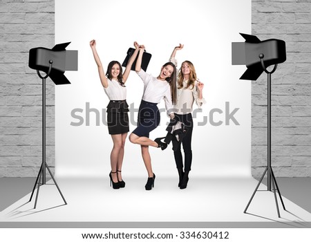 Business women in photo studio room with white cloth and spotlights Royalty-Free Stock Photo #334630412