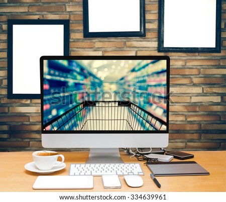 workspace on brick wall background with advertise frame show Abstract blurred photo of store with trolley in department store bokeh background, online shopping concept