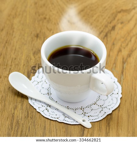 Black coffee in white cup on the table.
