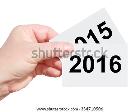 Hand holding card with figures 2016 over 2015 - Two thousand sixteen new year coming -  Two thousand fifteen year  leaving (one year replaces another). Isolated on a white background