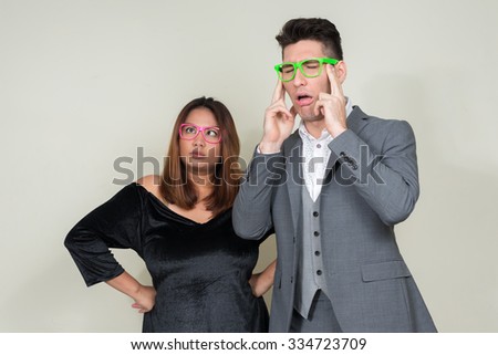 Man and woman wearing colorful eyeglasses