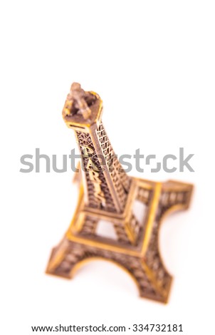 Photo of little model of Eiffel Tower isolated on white. Image of travel in France and symbol of Paris.