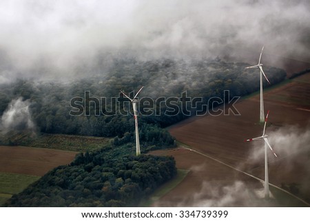 Panorama spectacular skyline view of cloudy blue sky from airplane window over windfarm landscape background wind turbines renewable power energy stations, horizontal picture 