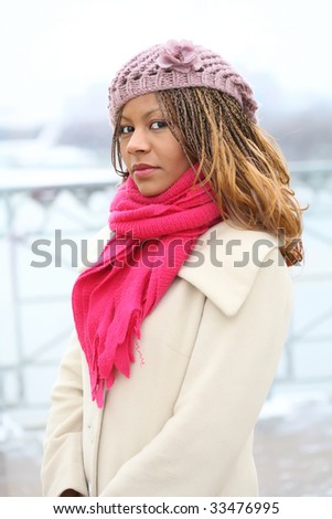young woman in warm clothes on the winter background