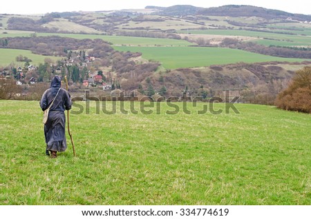 lonely monk walking in nature. Man in fantasy larp  monk costume in nature.  Royalty-Free Stock Photo #334774619