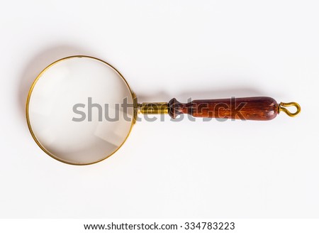 Photo of a Brass Magnifying Glass with wooden handle, isolated on white background with clipping path for both the outline and internal glass area.