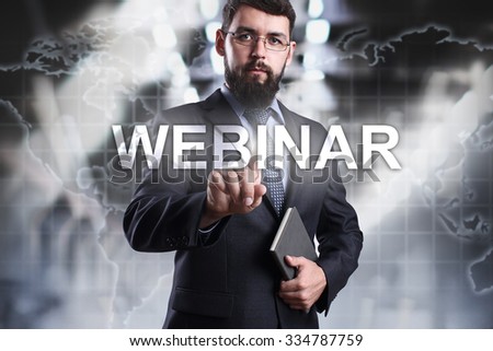Businessman pressing button on touch screen interface and select Webinar. Business concept. Internet concept.