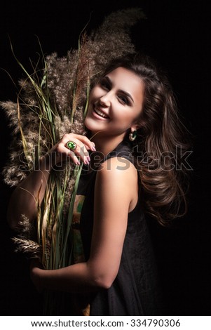 beautiful girl on a black background holding canes in their hands