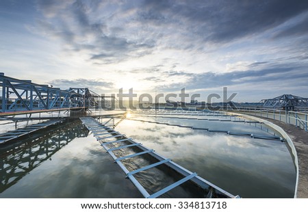 The Solid Contact Clarifier Tank type Sludge Recirculation process in Water Treatment plant with sunrise Royalty-Free Stock Photo #334813718