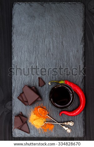 Mexican spicy hot chocolate with chili pepper and cinnamon. Top view from above, free text copy space background