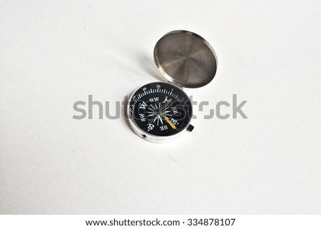 Compass. Photo of magnetic compass on white background.