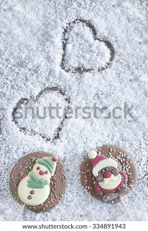 Christmas frame with chocolate figures on a snowy background