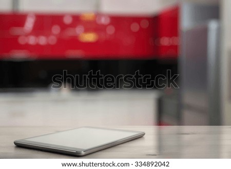 tablet on wooden table in the kitchen