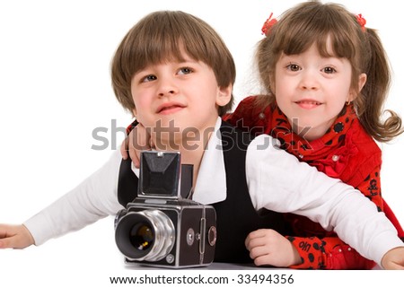 Adorable children taking pictures with photo camera