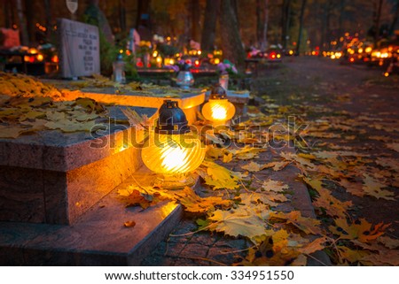 Colorful candles on the cemetery at All Saints Day, Poland Royalty-Free Stock Photo #334951550