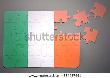 broken puzzle with the national flag of ireland on a gray background