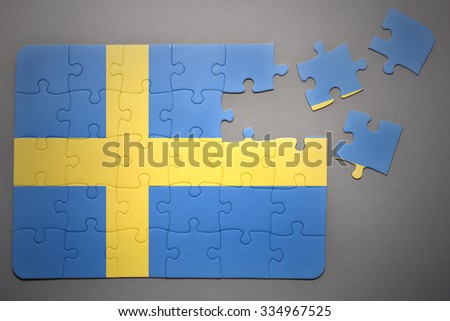 broken puzzle with the national flag of sweden on a gray background