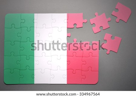 broken puzzle with the national flag of italy on a gray background