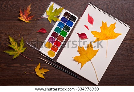 watercolor, brushes, album and autumn leaves, fall concept
