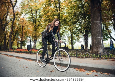 young female riding a bicycle, girl with fixed gear bike