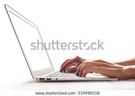 young female hands typing on a laptop keyboard with blank screen, isolated on white              