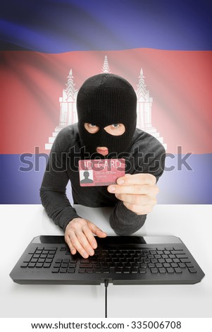 Hacker with ID card in hand and flag on background - Cambodia