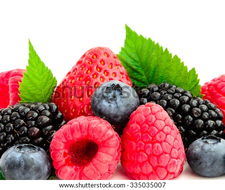 Close-up view of mixed, assorted berries blackberry, strawberry, blueberry, raspberry with green leave isolated on white background. Colorful and healthy concept. Black, blue, red, green color
