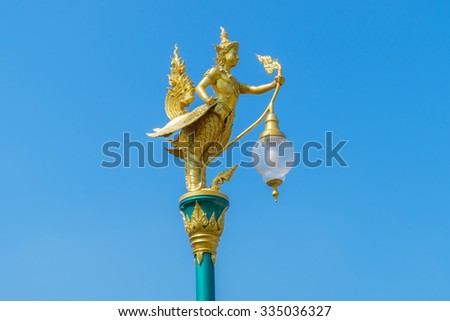 Kinnaree, golden sky background.