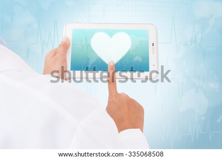 Doctor hand touch screen heart symbol on a tablet. medical icon