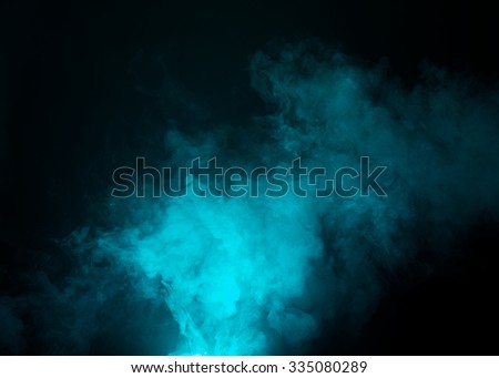 Dark background with cyan, blue fog floating in the air. 