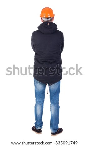 Back view of an engineer in  construction helmet stands.  Standing young guy in parka. Rear view people collection.  backside view of person.  Isolated over white background.