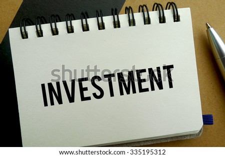 Investment memo written on a notebook with pen
