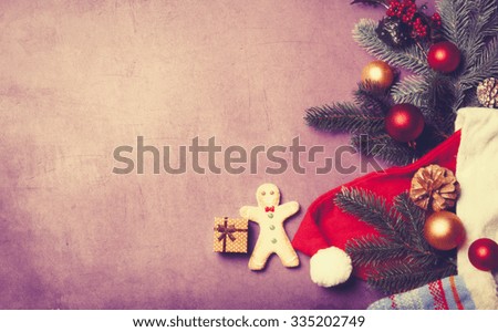 Christmas gift and gingerbread man on violet background